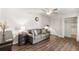 Cozy living room featuring hardwood floors, a gray sofa, and a closet with an open door at 3228 Clairmont North Ne # 3228-A, Brookhaven, GA 30329