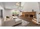Bright living room with wood floors, dining area, comfortable seating, brick fireplace and outdoor access at 3228 Clairmont North Ne # 3228-A, Brookhaven, GA 30329
