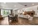 Spacious living room with wood floors, a brick fireplace, a dining area, and large windows with outdoor views at 3228 Clairmont North Ne # 3228-A, Brookhaven, GA 30329