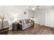 Cozy living room with ceiling fan, hardwood floors, a gray sofa, and closet with paneled doors at 3228 Clairmont North Ne # 3228-A, Brookhaven, GA 30329
