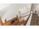 Elegant staircase with hardwood floors, white railing, brick fireplace and modern lighting fixtures at 3228 Clairmont North Ne # 3228-A, Brookhaven, GA 30329