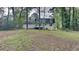 A sprawling backyard with a deck is surrounded by mature trees, perfect for outdoor entertaining at 6413 Swift Creek Dr, Lithonia, GA 30058