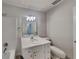 Well-lit bathroom with white vanity, mirror, and a shower and tub with tile surround at 6413 Swift Creek Dr, Lithonia, GA 30058
