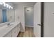 Bright bathroom featuring a vanity with a white countertop and cabinets plus a framed mirror at 6413 Swift Creek Dr, Lithonia, GA 30058