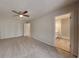 Spacious bedroom with carpet, closet, ceiling fan and a view into the bathroom at 6413 Swift Creek Dr, Lithonia, GA 30058