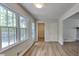 Open-concept area featuring hardwood flooring, abundant natural light, and flexible space at 6413 Swift Creek Dr, Lithonia, GA 30058