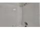 White tiled shower with updated shower head and hardware at 6413 Swift Creek Dr, Lithonia, GA 30058