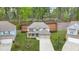 Aerial view of a two story home with stone accents, a lush lawn, and an attached two car garage at 6917 Demeter Dr, Atlanta, GA 30349