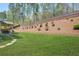 A well-manicured backyard offers a patio area with grilling and dining space at 6917 Demeter Dr, Atlanta, GA 30349