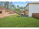 A lush, green backyard with patio for outdoor relaxation and entertainment at 6917 Demeter Dr, Atlanta, GA 30349