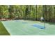 Full basketball court surrounded by lush trees for recreational enjoyment at 6917 Demeter Dr, Atlanta, GA 30349