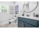 Stylish bathroom featuring dark blue vanity cabinets, modern fixtures, and art at 6917 Demeter Dr, Atlanta, GA 30349