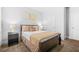 Cozy bedroom featuring neutral walls, carpet, and a dark sleigh bed with gold and brown accents at 6917 Demeter Dr, Atlanta, GA 30349
