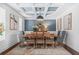 Formal dining room with coffered ceiling, wainscoting, and a large dining table at 6917 Demeter Dr, Atlanta, GA 30349