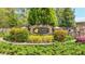 Stone entryway sign reading 'Camden Manor' surrounded by lush landscaping at 6917 Demeter Dr, Atlanta, GA 30349