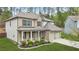 Attractive two-story home featuring a blend of stone and brick, a covered porch, and an attached two-car garage at 6917 Demeter Dr, Atlanta, GA 30349