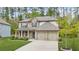 Charming two-story home with a mix of stone and brick, a welcoming front porch, and an attached two-car garage at 6917 Demeter Dr, Atlanta, GA 30349
