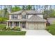 Beautiful two-story home with stone and brick accents, complemented by a well-manicured front yard and two-car garage at 6917 Demeter Dr, Atlanta, GA 30349