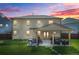 A home's backyard boasts a covered patio, grill, and manicured lawn at 6917 Demeter Dr, Atlanta, GA 30349