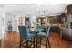 Open kitchen with stainless steel appliances, dark wood cabinets, and a glass dining table at 6917 Demeter Dr, Atlanta, GA 30349