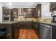 Modern kitchen with dark cabinets, stainless steel appliances, and granite countertops at 6917 Demeter Dr, Atlanta, GA 30349