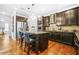 Modern kitchen featuring dark wood cabinets, stainless steel appliances, and granite countertops at 6917 Demeter Dr, Atlanta, GA 30349