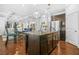 A spacious kitchen with a large center island, stainless steel appliances, and hardwood flooring, perfect for Gathering meals at 6917 Demeter Dr, Atlanta, GA 30349