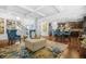 Open-concept living room flowing into the kitchen, featuring hardwood floors and stylish blue accents at 6917 Demeter Dr, Atlanta, GA 30349