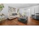 Bright living room featuring hardwood floors, neutral colors, stylish decor, and access to the upper floor at 6917 Demeter Dr, Atlanta, GA 30349