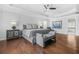 A serene main bedroom suite featuring a tray ceiling, hardwood floors, and a cozy sitting area for ultimate relaxation at 6917 Demeter Dr, Atlanta, GA 30349