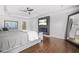 Modern main bedroom featuring tray ceiling, electric fireplace and a large mirror at 6917 Demeter Dr, Atlanta, GA 30349