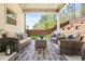 Outdoor living with stylish furniture on the covered patio overlooking a lush, green backyard at 6917 Demeter Dr, Atlanta, GA 30349