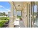 Inviting covered front porch with stone columns and decorative potted plants at 6917 Demeter Dr, Atlanta, GA 30349