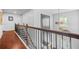 Elegant staircase with iron railing and hardwood steps, leading to the upper level, offering a stylish transition at 6917 Demeter Dr, Atlanta, GA 30349