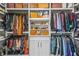 A spacious walk-in closet with custom shelving, ample storage for shoes and designer clothes, and soft lighting at 6917 Demeter Dr, Atlanta, GA 30349