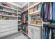 Organized walk-in closet with custom shelving, drawers, and hanging space for a complete wardrobe solution at 6917 Demeter Dr, Atlanta, GA 30349