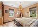 Comfortable bedroom with hardwood floors, two windows, and built-in storage at 1015 S Candler St, Decatur, GA 30030