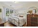 Bright bedroom featuring hardwood floors, a black metal bed frame, and natural light from large window at 1015 S Candler St, Decatur, GA 30030