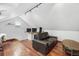Versatile bonus room with hardwood floors, a comfortable couch, and dual monitor workspace at 1015 S Candler St, Decatur, GA 30030