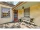 Charming front porch with a red door, welcome mat and quaint bench seating at 1015 S Candler St, Decatur, GA 30030