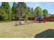 Spacious backyard with playground equipment, swing set and bench seating at 2881 Terra View Sw Dr, Lilburn, GA 30047