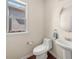 Bright half-bathroom with pedestal sink, tile floors, and large window at 2881 Terra View Sw Dr, Lilburn, GA 30047