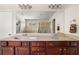 Bathroom featuring a double vanity with dark wood cabinets and a large mirror at 2881 Terra View Sw Dr, Lilburn, GA 30047