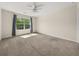 Spacious bedroom with carpeted floors, a ceiling fan, and natural light from the window at 2881 Terra View Sw Dr, Lilburn, GA 30047
