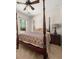 Bedroom features a four-poster bed and a view to the outdoors at 2881 Terra View Sw Dr, Lilburn, GA 30047