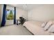 Bright bedroom with a large window and an adjacent desk and work area at 2881 Terra View Sw Dr, Lilburn, GA 30047