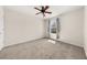 Cozy bedroom with carpeted floors, ceiling fan, and natural light from the window at 2881 Terra View Sw Dr, Lilburn, GA 30047