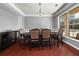 Dining room with hardwood floors, a large window, and a dark wood table at 2881 Terra View Sw Dr, Lilburn, GA 30047