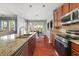 Bright kitchen boasts granite countertops, stainless steel appliances, and an open view to dining area at 2881 Terra View Sw Dr, Lilburn, GA 30047