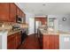 Modern kitchen featuring granite countertops, stainless steel appliances, and dark wood cabinetry at 2881 Terra View Sw Dr, Lilburn, GA 30047